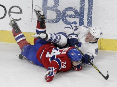 Defenceman Alexei Emelin of the Montreal Canadiens and defenceman Morgan Rielly of the Toronto Maple Leafs collide in the second period of an  NHL game at the Bell Centre in  Montreal on Saturday, October 24, 2015, in Montreal.