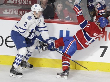 Forward Brendan Gallagher of the Montreal Canadiens is hit by Matt Hunwick of the Toronto Maple Leafs in the first period of an NHL game at the Bell Centre in  Montreal on Saturday, October 24, 2015, in Montreal.