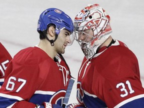 Goalie Carey Price (left) and captain Max Pacioretty of the Montreal Canadiens celebrate the team's victory against the Toronto Maple Leafs in an NHL game at the Bell Centre in  Montreal on Saturday, October 24, 2015, in Montreal.