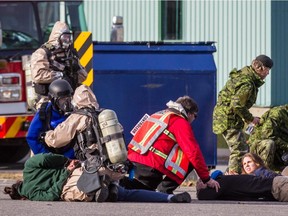 Montreal police and RCMP tactical units hold a terrorism attack simulation at the CFB Montreal (Longue-Pointe) military base in Montreal on Saturday, Oct. 24, 2015.