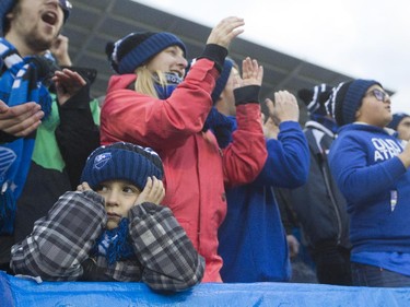 A young  Montreal Impact fan blocks his ears from the sounds of cheering fans in the first half of a game against Toronto FC at Saputo stadium in Montreal Sunday, October 25, 2015. It was the final game of the M.L.S. season for the Impact.