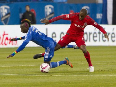 Dominic Oduro of the Montreal Impact is tripped up by Jackson of Toronto FC in the first half of a game at Saputo stadium in Montreal Sunday, October 25, 2015. It was the final game of the M.L.S. season for the Impact.