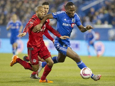 Forward Didier Drogba of the Montreal Impact tries fend off Justin Morrow of Toronto FC in the second half of the final game of the M.L.S. season for the Impact at Saputo stadium in Montreal Sunday, October 25, 2015.