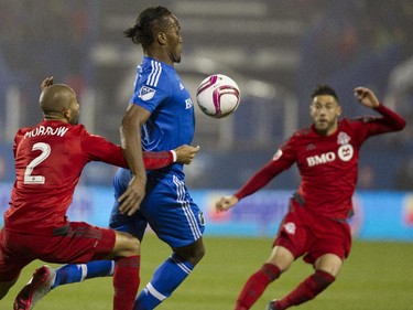 Forward Didier Drogba of the Montreal Impact tries to control the ball against Justin Morrow (left) of Toronto FC in the second half of the final game of the M.L.S. season for the Impact at Saputo stadium in Montreal Sunday, October 25, 2015.