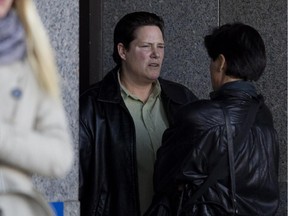 Police officer Stéfanie Trudeau, Agent 728, centre, takes a cigarette break outside the Montreal courthouse in Montreal on Tuesday October 27, 2015.  (Allen McInnis / MONTREAL GAZETTE)