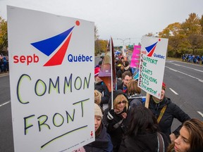 Teachers and support staff from the Riverside School Board protest against government cuts as part of a larger province-wide rolling protests outside the ACCESS school St-Lambert on Wednesday, October 28, 2015.