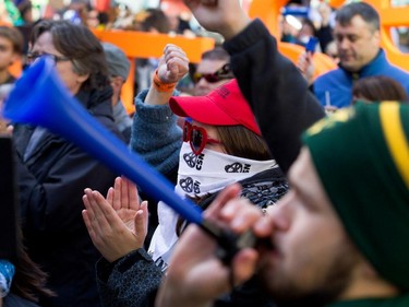 People cheer anti- government speeches as they join a crowd estimated at over 100,000 people taking part in coalition of public-sector unions demonstration in Montreal on Saturday October 3, 2015.  The groups are protesting the Couillard government's contract offer to unions representing provincial level workers.