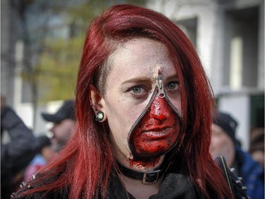 Juliana Truchi unzips her face so she can take part in Montreal's Zombie Walk on Saturday, October 31, 2015.