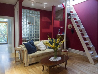 A view of a sitting room with a ladder/stairway leading to a rooftop deck at the home of Diane Hébert in Montreal Tuesday, September 1, 2015. Hébert is a jazz vocalist working part-time in a local pastry shop and raising two children. In 1985, she and two female friends bought this Plateau triplex and have renovated it over the decades. (John Kenney / MONTREAL GAZETTE)