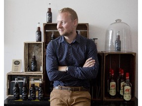 Bastien Poulain with bottles of 1642, a cola made with maple syrup, in Montreal, Friday Sept. 11, 2015.  He is the creator and gets all his ingredients locally and packages the product in the city as well.