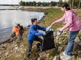 Volunteers pick up garbage  along the shoreline near Baie-d'Urfré town hall.