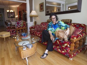 Stephanie Carrière with her dog Bamboo in her living room in N.D.G. The place, which she shares with husband, professional jeweller Jean-Luc Bensadoun, is decorated with retro furnishings from top to bottom.  (Phil Carpenter / MONTREAL GAZETTE)