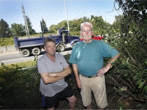 A new sound barrier may get more funding than usual from the Quebec government. Derrick Pounds, right, has been advocating for it for years and lives near the problem area. Pounds stands next to Highway 20 with his neighbour Dominic Orlando's (left).