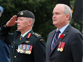 National Defence Chief Jonathan Vance, left, and Veterans Affairs Minister Erin O'Toole take part in a commemoration ceremony of the 70th anniversary of the end of the Second World War in the Far East, or V-J Day (Victory Over Japan) at the National War Memorial in Ottawa on Saturday, August 15, 2015.