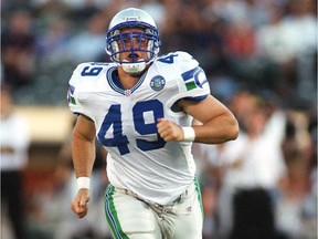 J.P. Darche runs onto the field during his NFL playing days with the Seattle Seahawks.