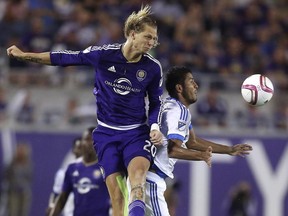 Orlando City's Brek Shea goes up for a header with Montreal Impact's Johan Venegas during their MLS soccer game at the Citrus Bowl in Orlando, Saturday, Oct. 3, 2015.