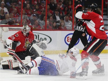 The Ottawa Senators took part in their home opener against the Montreal Canadiens at Canadian Tire Centre in Ottawa Ontario Sunday Oct 11, 2015. Ottawa Senators Jared Cowen pulls down Brendan Gallagher from the Montreal Canadiens during second period action Sunday, OCt. 11, 2015.