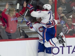 A fan cheers as Montreal Canadiens defenseman P.K. Subban jumps into the arms of teammate Torrey Mitchell after he scored during third period NHL action against the Ottawa Senators Sunday, October 11, 2015 in Ottawa. The Canadiens defeated the Senators 3-1.