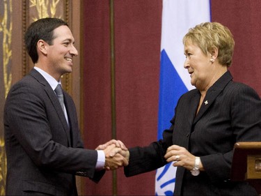 Quebec Premier Pauline Marois shakes hand with Treasury Board President Stéphane Bédard as she introduces members of her cabinet during a ceremony Wednesday, September 19, 2012 at the legislature in Quebec City.