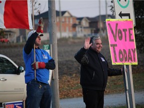 Before the polls closed on voting day, Conservative candidate Peter Van Loan and supporters stood on County Rd. 88 and encouraged voters to get out and cast their ballot, in Bradford, Ont. on Monday October 19, 2015.