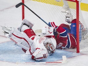 The Canadiens' Brendan Gallagher crashes into Detroit Red Wings goaltender Petr Mrazek after scoring power-play goal in second period of 4-1 victory at the Bell Centre in Montreal on Oct. 17, 2015.