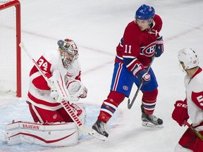 Detroit Red Wings' goaltender Petr Mrazek, left, (34) makes a save against Montreal Canadiens' Brendan Gallagher (11) as Red Wings' Jonathan Ericisson defends during first period NHL hockey action in Montreal, Saturday, Oct. 17, 2015.