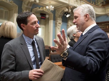 Quebec Premier Philippe Couillard, right, and Quebec Opposition Leader Stéphane Bédard chat after they exchanged season's greetings as the fall session comes to an end Friday, December 5, 2014 at the legislature in Quebec City.