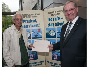 Pointe-Claire resident Edward MacKay, left, received the Good Behaviour Award from Mayor Morris Trudeau for his safe driving practices.