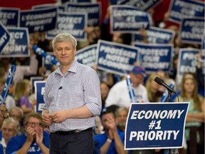Prime Minister Stephen Harper addresses supporters during a campaign stop at The OTC Group in London, Ont. on Tuesday October 13, 2015.