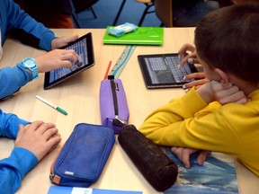 Students use tablets and other tools.