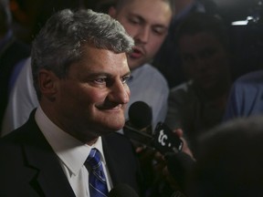 Gérard Deltell speaks to a reporter at the Conservative rally in  Quebec City on Oct. 19, 2015.