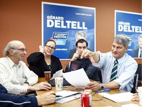 Conservative candidate in the riding of Louis-Saint-Laurent, Gérard Deltell, speaks with his campaign team in their office in Quebec City on Tuesday October 13, 2015.