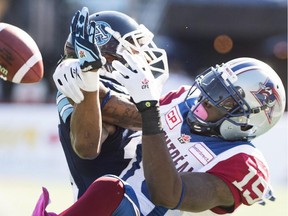Montreal Alouettes' S.J. Green, right, challenges Toronto Argonauts' A.J. Jefferson during first half CFL football action in Montreal, Monday, Oct. 12, 2015.