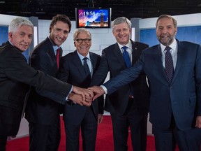 The Bloc Québécois' Gilles Duceppe (from left), Liberal Leader Justin Trudeau, moderator Pierre Bruneau, Conservative Prime Minister Stephen Harper and the NDP’s Tom Mulcair smile for a pre-debate photo.