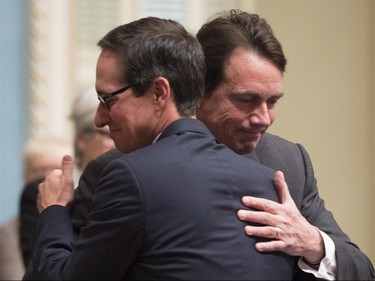 Quebec Opposition MNA Stéphane Bédard gets a hug from Quebec Opposition Leader Pierre-Karl Peladeau, right, after he announced his decision to resign, Thursday, October 22, 2015 at the legislature in Quebec City.