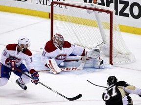 Montreal Canadiens goalie Carey Price (31) stops a shot by Pittsburgh Penguins' Sidney Crosby (87) with Andrei Markov (79) defending during the third period of an NHL hockey game in Pittsburgh Tuesday, Oct. 13, 2015. The Canadiens won 3-2.