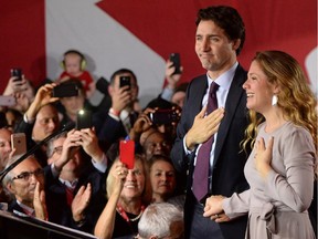 Phil Fontaine, bottom left, watches Liberal leader Justin Trudeau and wife Sophie Gregoire arrive to Liberal election headquarters in Montreal on Monday, October 20, 2015.