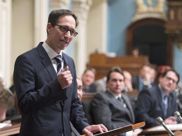 Quebec Opposition MNA Stéphane Bédard announces his decision to resign, Thursday, October 22, 2015 at the legislature in Quebec City. Quebec Opposition Leader Pierre-Karl Peladeau, centre, and Quebec Opposition MNA Bernard Drainville, right, look on.