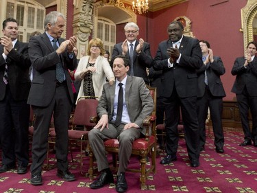 Quebec Acting Opposition Leader Stephane Bedard, centre, is applauded by colleagues after being sworn in on Tuesday, April 22, 2014 at the legislature in Quebec City.