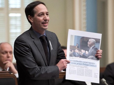 Quebec Opposition Leader Stéphane Bédard holds a copy of a Montreal newspaper while criticizing the government, during question period Thursday, December 4, 2014 at the legislature in Quebec City.