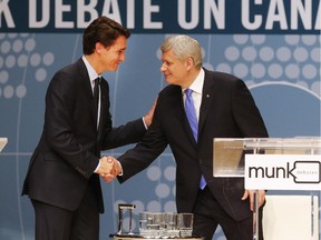 Conservative Leader Stephen Harper, right, and Liberal Leader Justin Trudeau shake hands following the Munk Debate on Canada's foreign policy in Toronto, on Monday, Sept. 28, 2015. Did Harper's strategy that long campaign would favour the Conservatives backfire?