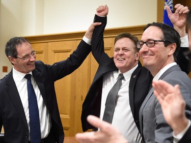 Newly elected Parti Quebecois MNA Sylvain Rochon, centre is congratulated by Opposition Leader Stéphane Bédard, right, and MNA Sylvain Page at the begining of a party caucus meeting Tuesday, March 17, 2015 at the legislature in Quebec City. Rochon won a byelection in the riding of Richelieu on March 9.