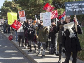 Teachers and workers from Vanier College take part in a province-wide rotating strike Monday, October 26, 2015 in Montreal to protest against government austerity measures.
