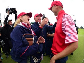 Jan Haas and Captain Jay Haas of the United States Team celebrate a win over the International Team 15.5 to 14.5 with their son Bill Haas on the 18 green during the Sunday singles matches at The Presidents Cup at Jack Nicklaus Golf Club Korea on Oct. 11, 2015 in Songdo IBD, Incheon City, South Korea.