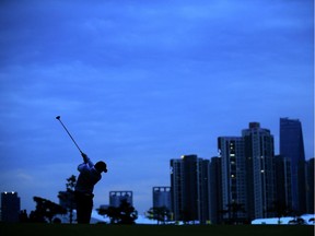 Louis Oosthuizen of South Africa and the International plays his second shot at the 18th hole in his match with Branden Grace against Bubba Watson and J.B.Holmes of the United States team during the Saturday afternoon fourball matches at The Presidents Cup at Jack Nicklaus Golf Club Korea on Oct. 10, 2015, in Songdo IBD, Incheon City, South Korea.