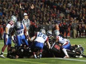 The ref signals a touchdown as Ottawa Redblacks cross the line during first half CFL football action against the Montreal Alouettes in Ottawa on Thursday Oct. 1, 2015.