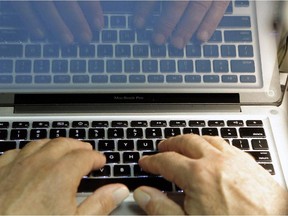 This photo illustration shows hands typing on a computer keyboard.