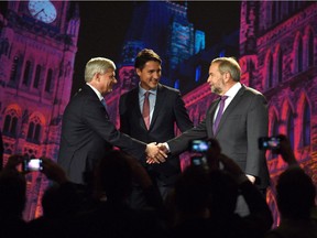 Conservative leader Stephen Harper and NDP leader Tom Mulcair shake hands as Liberal leader Justin Trudeau looks ahead of the Globe and Mail-hosted leaders' debate in Calgary on Sept. 17, 2015.