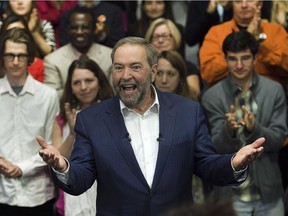 NDP Leader Tom Mulcair reacts to the applause as he arrives at a campaign stop in Montreal on Thursday, Oct. 1, 2015.
