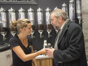 NDP leader Tom Mulcair gets a cup of coffee while campaigning Friday, October 16, 2015 in Lac Megantic.